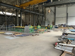 Line for the production of corrugated sheets and metal tiles